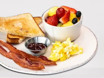 Bacon and Egg breakfast from First Watch, featuring crispy bacon, a cage-free egg cooked to your preference, served with sourdough toast and fresh seasonal fruit.
