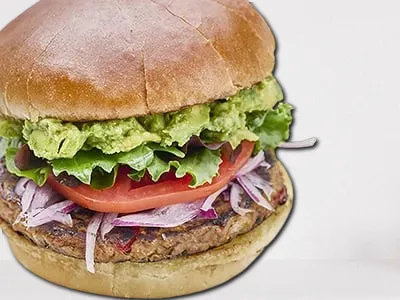 Baja Turkey Burger from First Watch, featuring a lean turkey patty, avocado, organic mixed greens, housemade pico de gallo, mayo, and Horseradish Havarti cheese on a brioche bun.
