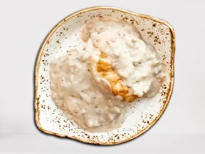 Biscuits & Gravy - two house-baked biscuits smothered in creamy turkey sausage gravy.