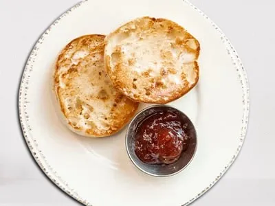 First Watch English Muffin - a toasted English muffin with a golden-brown crust, served warm.