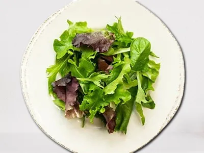 Lemon Dressed Greens from First Watch, featuring fresh organic mixed greens lightly dressed with a zesty lemon vinaigrette.