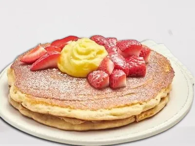 First Watch Lemon Ricotta Pancake - fluffy multigrain pancakes infused with whipped ricotta cheese, topped with seasonal berries, creamy lemon curd, and powdered cinnamon sugar.