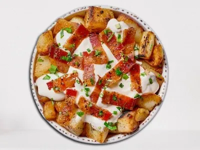 First Watch Million Dollar Pots - seasoned potatoes topped with Million Dollar Bacon, Parmesan cream sauce, and fresh herbs.
