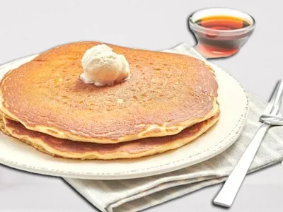 First Watch Multigrain Pancake 2 Core - two humongous multigrain pancakes served with whipped butter and warm syrup.