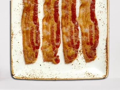 First Watch Side of Bacon - crispy and savory hardwood-smoked bacon strips served as a classic breakfast side.