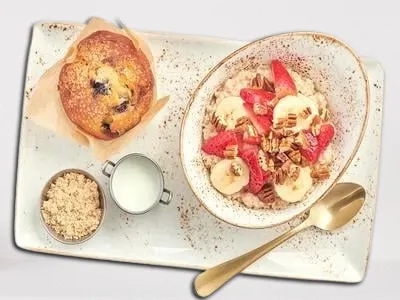 First Watch Steel-Cut Oatmeal - hearty oatmeal topped with fresh berries, bananas, pecans, and brown sugar.
