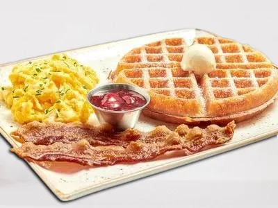 First Watch Tri-Fecta - two cage-free eggs any style, served with your choice of a Belgian waffle or multigrain pancake, and a side of bacon, chicken sausage patty, turkey, or pork sausage link.