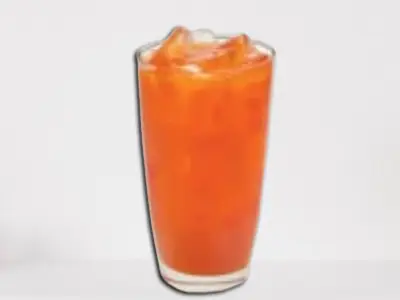 First Watch Tropical Sunrise juice in a tall glass with orange and red layers