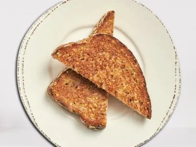 First Watch Whole Grain Artisan Toast - toasted whole grain artisan bread served with all-natural house preserves and whipped butter.
